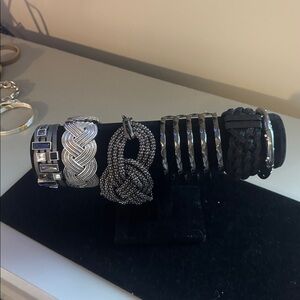 Six black/silver bold statement bracelets.